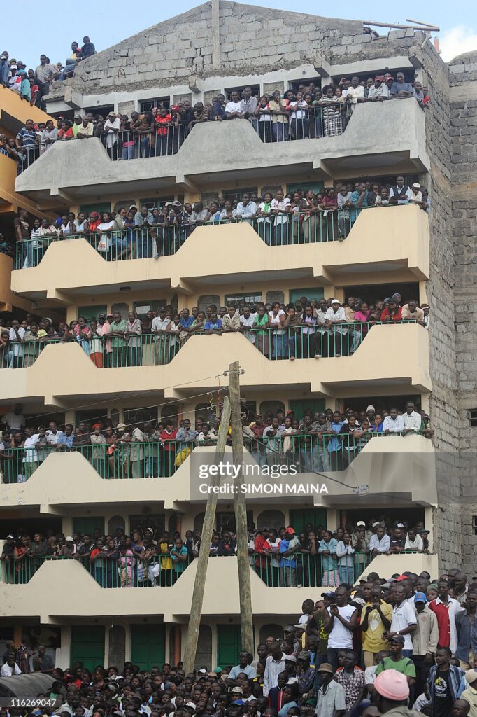 A crowd watches rescue efforts after a building collapsed on June 14, 2011 in Nairobi.